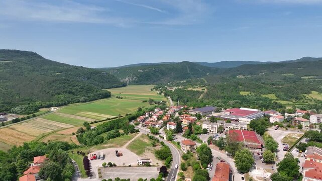 Aerial drone view of Buzet historic medieval town in Istria Croatia at early summer showing old stone buildings, hilltop settlement, surrounding forests and green valley landscape