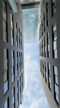 Modern buildings frame a bright blue sky