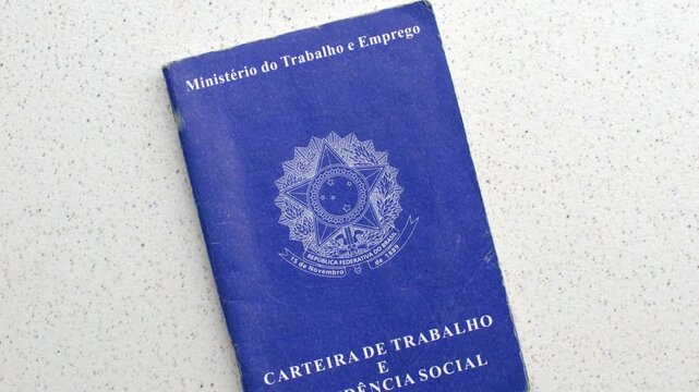 Brazilian Work ID. Unemployment, job, or salary increase. On a clear surface: Employment symbols reflected on the ID, depicting the pursuit of opportunities, laid on an illuminated table.