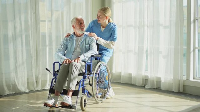 Help support retirement healthcare. Nurse helping old man in wheelchair. Patient and woman in nursing home for medical caregiver. Nurse taking care of paralyzed man in chair for people with disability