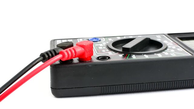 Close-up of a multimeter on a clear surface, highlighting precision and versatility for electrical measurements.
