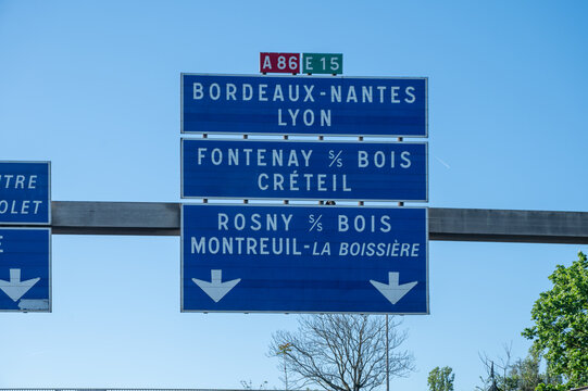 View of a French and European autoroute with overhead directional signs pointing to major cities like Paris, Bordeaux, Lille, Calais, showing lanes, traffic and motorway infrastructure, road signes
