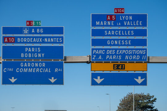 View of a French and European autoroute with overhead directional signs pointing to major cities like Paris, Bordeaux, Lille, Calais, showing lanes, traffic and motorway infrastructure, road signes