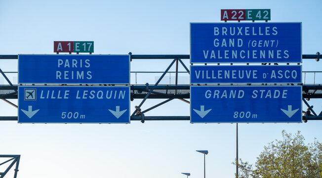View of a French and European autoroute with overhead directional signs pointing to major cities like Paris, Bordeaux, Lille, Calais, showing lanes, traffic and motorway infrastructure, road signes