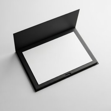 Open black presentation folder with a blank white sheet of paper inside on white