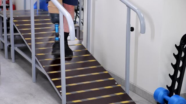 Amputee man with prosthetic leg walking down ramp for rehabilitation