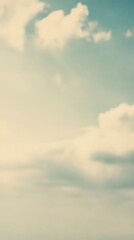Obraz premium Blue sky with white fluffy clouds. Soft natural background for design and creative projects. Heavenly atmosphere, peaceful daylight scenery with gentle sunlight and clear horizon.