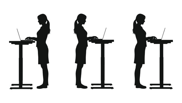 Silhouettes of women working on laptops at standing desks side view