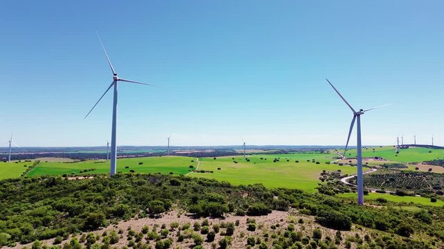 Aerial drone view wind turbines green field renewable energy landscape sustainable power