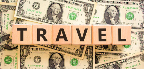 Naklejka premium Travel traveling touristic word symbol. Concept word Travel on beautiful blocks. Beautiful dollar bills background. Beautiful dollar bills. Business travel traveling touristic word concept. Copy space
