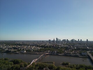 Warszawa - Polska - panorama Warszawy wykonana dronem. Rzeka Wisła, kościół, wieżowce, bloki, ulice w słoneczny dzień © Konrad