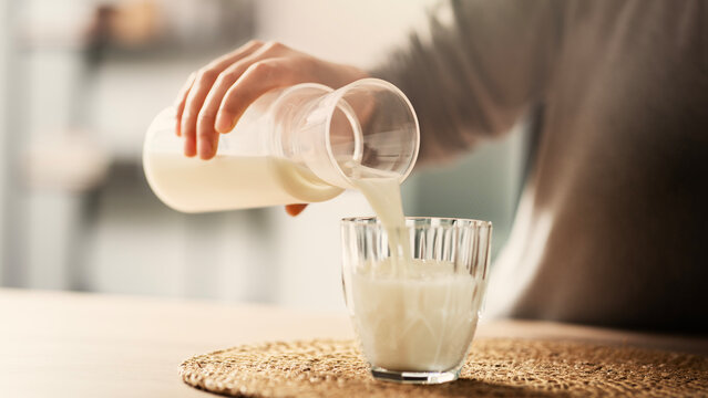 Woman pouring milk into a glass