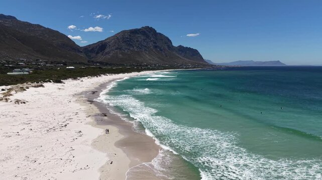 White sandy beach at Betty&rsquo;s Bay, South Africa, captured by drone from above, vivid summer colors, empty coastline, wide horizon, fresh air, calm atmosphere and sense of freedom.