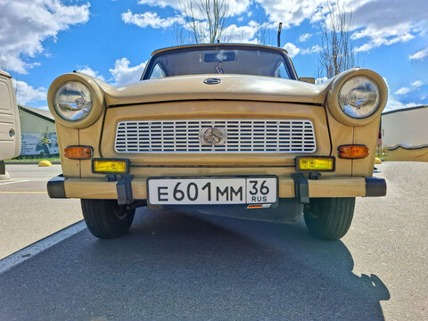 VORONEZH, Russia - April 25, 2026.Retro car show features East German Trabant with round headlights and simple grille in a low angle view under a bright blue sky