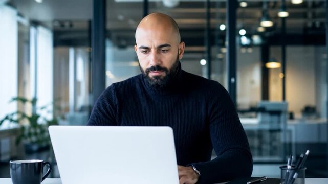 Business man working on laptop at office.