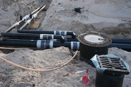 Underground insulated utility pipe junctions in trench for district heating construction project