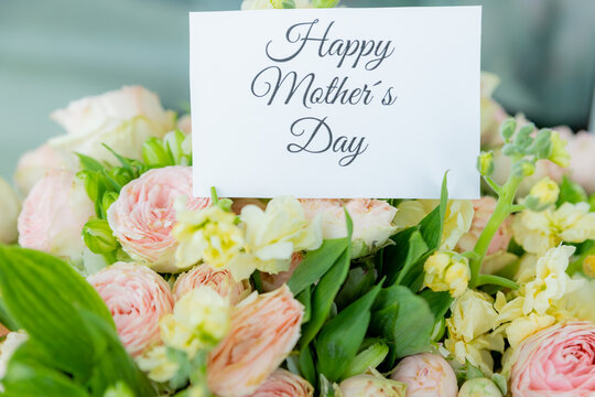 Happy Mother's Day Card and Bouquet. Flowers background. spring holiday concept.heart and blossoms.beautiful bright bouquet with a gift card with the text inscription.sweet wish concept