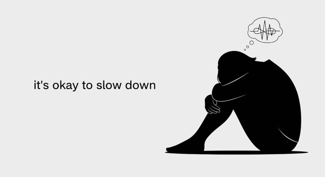 A person sitting curled up in a silhouette representing mental health and slowing down.