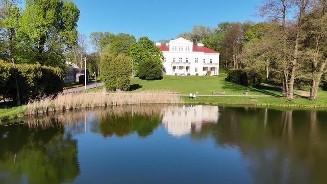Aerial view of Raczynski Palace reflection in Irydion Pond, Poland