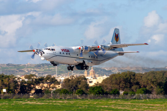 Luqa, Malta - December 12, 2005: Vega Airlines Antonov An-12BP (Reg.: LZ-VEC) on the signature smokey departure of the venerable An-12.