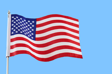 Fototapeta premium American flag waving in blue sky representing patriotism
