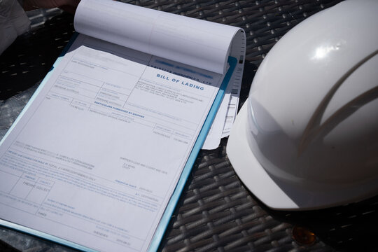 A tablet with documents or bill of lading a protective helmet.