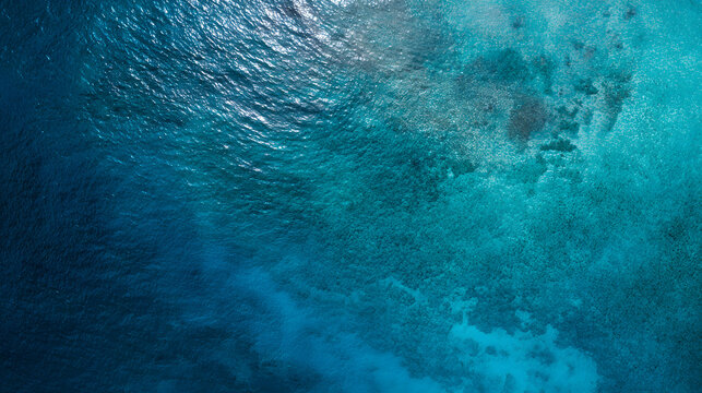 Top view of deep blue sea water surface with small ripples, aerial drone shot of turquoise ocean texture at island with abstract nature background.