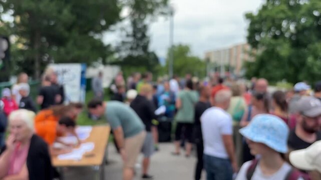 Blurred crowd of people at an outdoor event, concept of public gathering, festival atmosphere, large group.