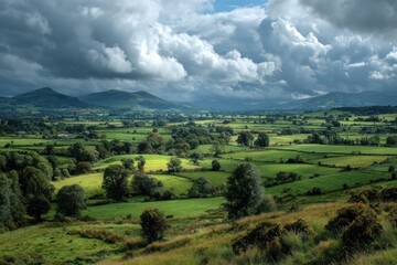 Obraz premium Serene Rolling Hills and Lush Greenery Under Dramatic Sky