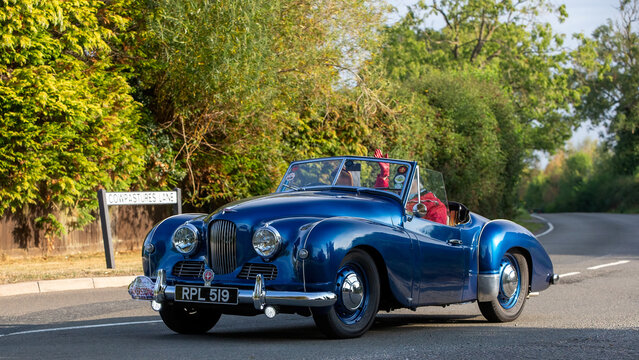 Whittlebury,Norhants,UK - Aug 23rd 2025:  1952 blue Jowett Jupiter classic British sports car  car driving on a British road