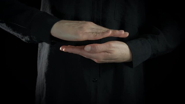 Man put hands parallel. Man put the hands like parallel and make the magic gesture indoor