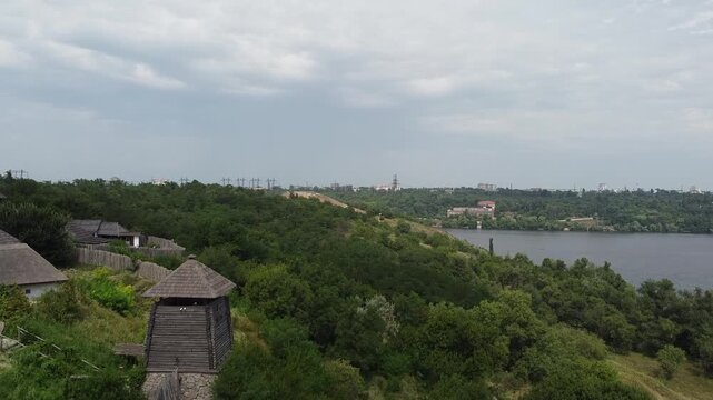 Horizontal drone footage of Khortytsia Island in Zaporizhzhia, Ukraine, showcasing historic wooden structures and the ancient heritage of the Cossacks