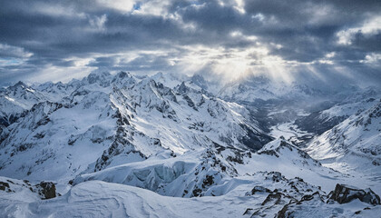 Obraz premium Snowy mountain range under cloudy sky.