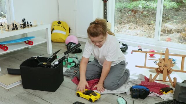 Children cleaning up messy kids playroom. Kid picking up toys. Funny child helping family with housework. Kid cleaning messy play area at home. Child organizing playroom toys.
