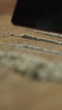 Credit card, drugs and lines on table for addiction with illegal substance, powder and closeup. Narcotics, cutting and prepare with dust, criminal offence and cocaine abuse with dependence on opioid