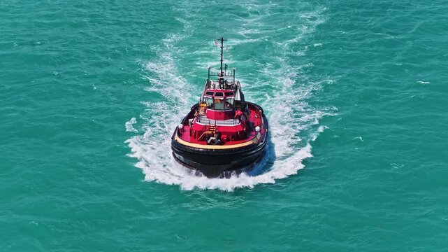 Boating and tugging. Tugboat sea transportation. Boat tug at sea. Aerial footage of tow boat transportation. Tugboat sailing at sea top view. Motor boat