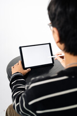 Person Using Digital Tablet with Stylus on Minimalist Background © febdwithart