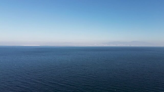 Aerial Drone Flight Over Calm Sea Revealing Coastline in Izmir Turkiye