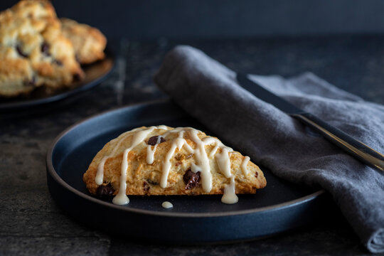 Scone with icing on plate