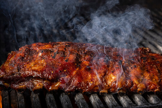 Ribs on grill with smoke