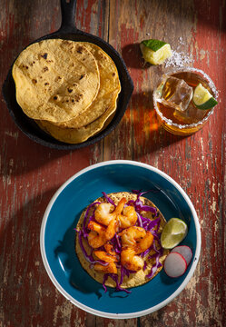 Overhead shot shrimp taco with tortillas and drink