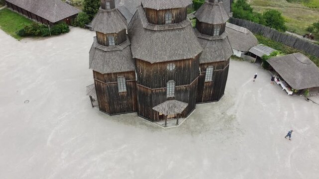 Horizontal drone footage of Khortytsia Island in Zaporizhzhia, Ukraine, featuring a historic wooden Cossack settlement with a traditional old Orthodox church