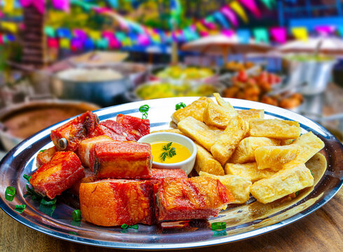 Brazilian fried pork ribs and cassava (mandioca) served on a plate, with a festive June Festival (Festa Junina) background featuring colorful flags and traditional food.