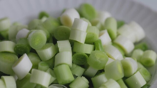 Close-up of fresh sliced leeks on a wooden cutting board