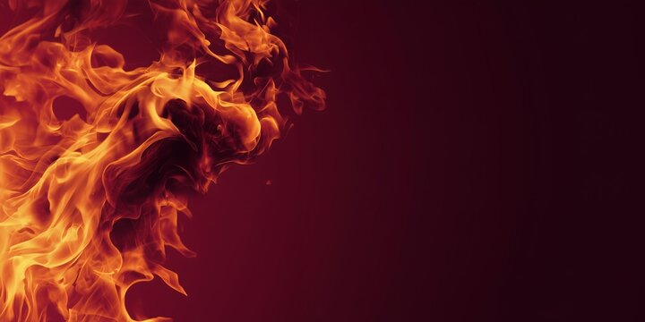 Vibrant orange and yellow flames lick the dark red background with copy space, concept for energy marketing, passion projects and intense visual impact design