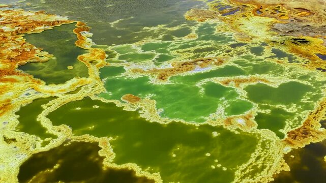 Aerial view of the colorful sulfur pools and salt formations of the Danakil Desert with vibrant green and yellow mineral deposits Dalol, Afar, Ethiopia.