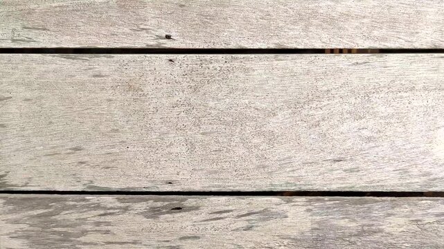 Weathered light gray wood planks texture, rustic timber board background with natural grain and horizontal lines. Perfect for use as a background, website backdrop, or architectural material overlay.