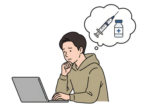 ノートパソコンの前で注射器とワクチンを思い浮かべて悩む若い日本人男性