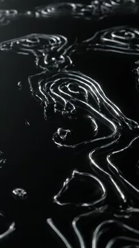 Elegant Abstract Topography with fluid metallic silver lines on a dark background for luxury branding and tech presentations. Vertical. Video. Portrait Orientation.