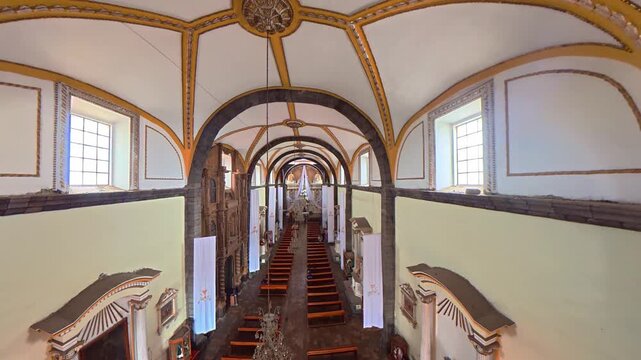 Ornate mexican church interior with arched vaulted ceiling
